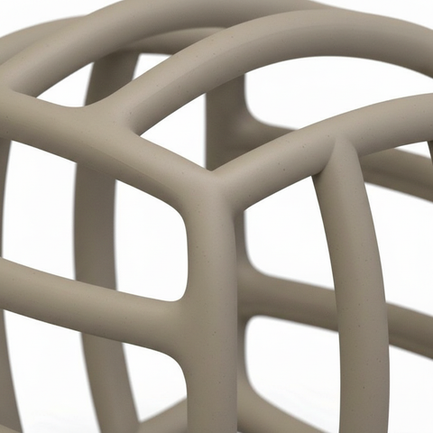Close-up of flexible silicone ribs and open grid holes on BPA-free hollow maze baby teether, white background
