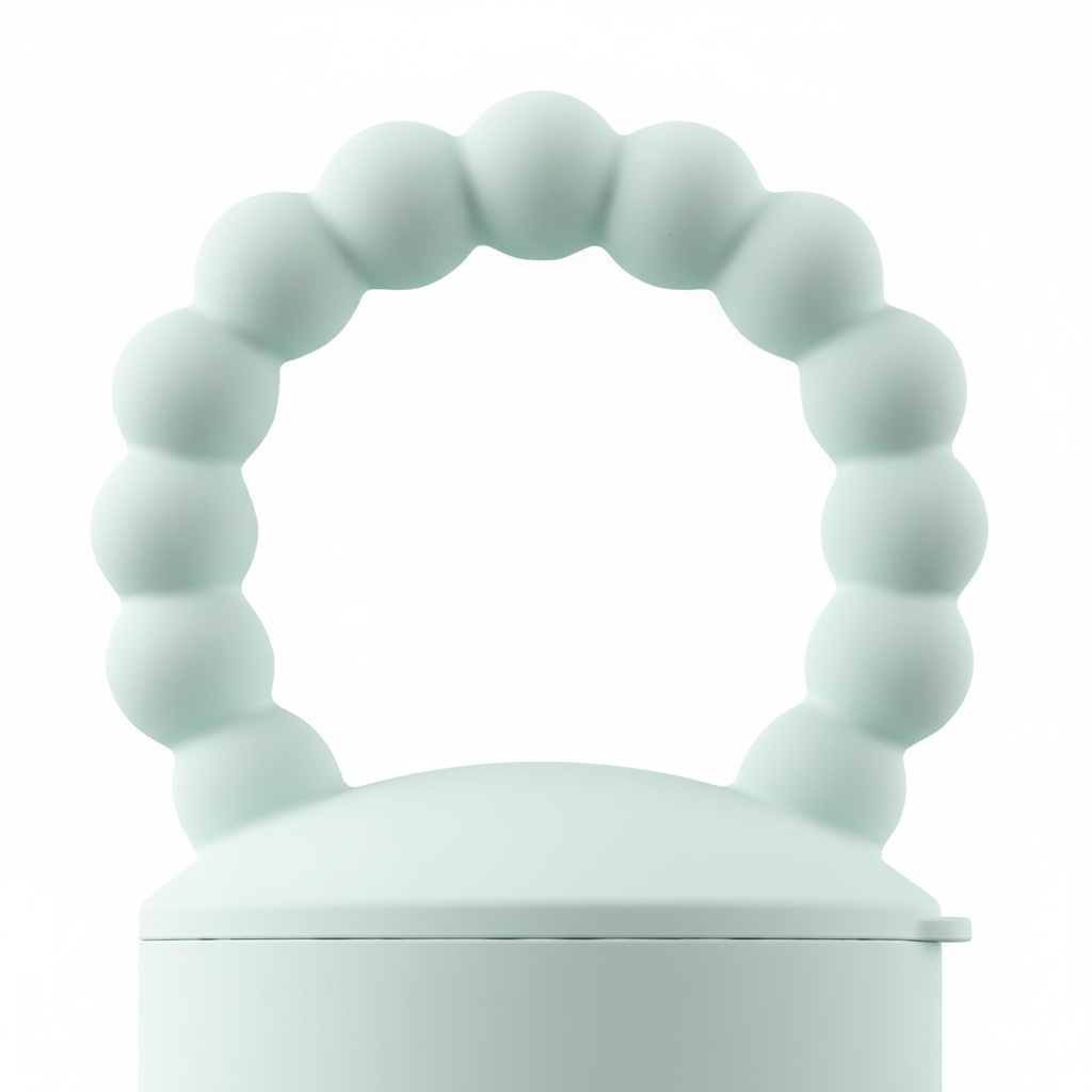 Close-up of mint green silicone beaded ring handle on BPA-free baby food feeder teether, white background
