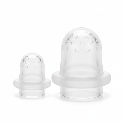 Close-up of two BPA-free clear silicone nipple inserts small and large for baby food feeder, white background